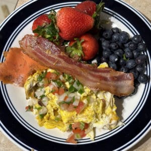 Breakfast with Pasture-raised Eggs, Uncured Bacon, Smoked Wild-Caught Sockeye Salmon, Strawberries & Blueberries.